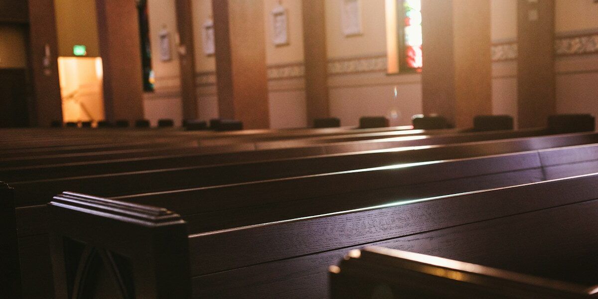 a church with pews and stained glass windows